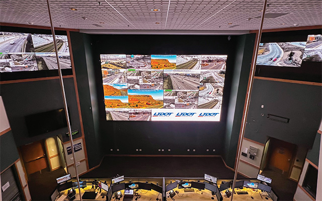 a bird’s eye view of a control room including 3 LED video walls