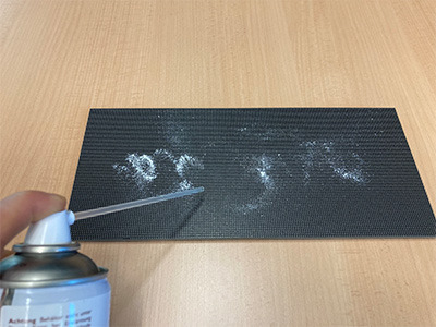 an LED pixel card being cleaned